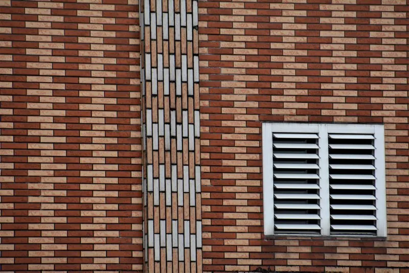 An air brick ventilation grille set into an exterior house wall