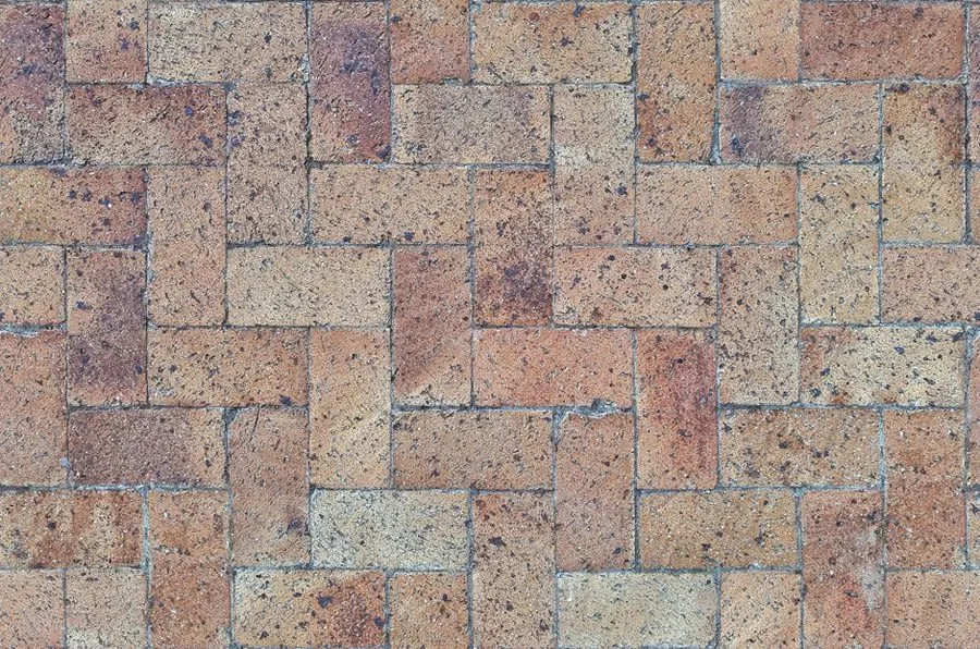 Herringbone block paving with open joints, a surface that genuinely benefits from sealing unlike resin bound
