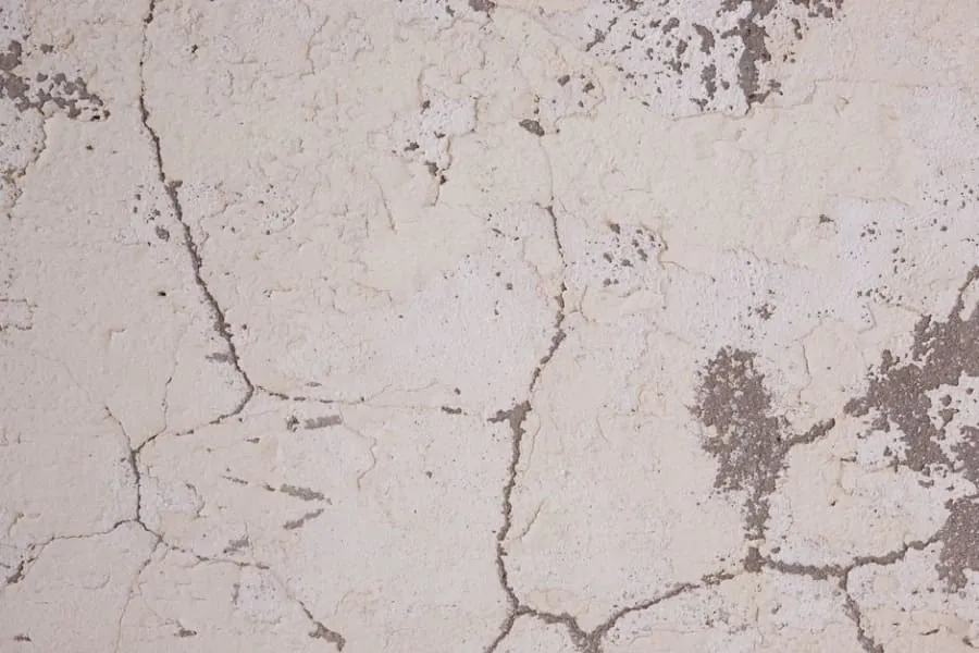 A cracked driveway damaged under heavy load