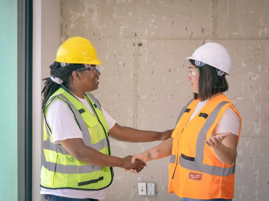A contractor shaking hands with a customer