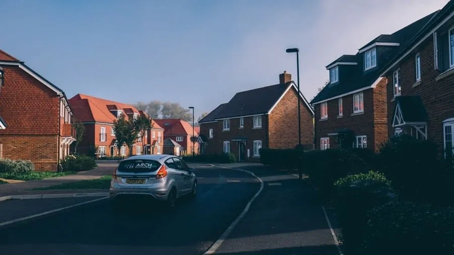 A modern estate street where driveways, kerbs and crossings are part of what a buyer takes on