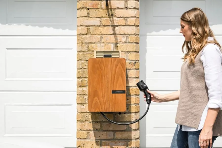 An electric car charging on a home driveway
