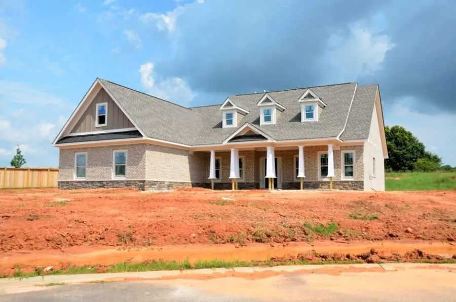 A family outside a new-build home