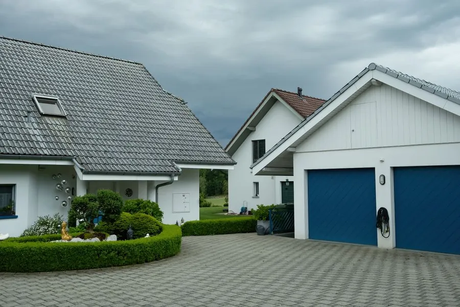 Suburban houses with garage doors meeting the driveway surface