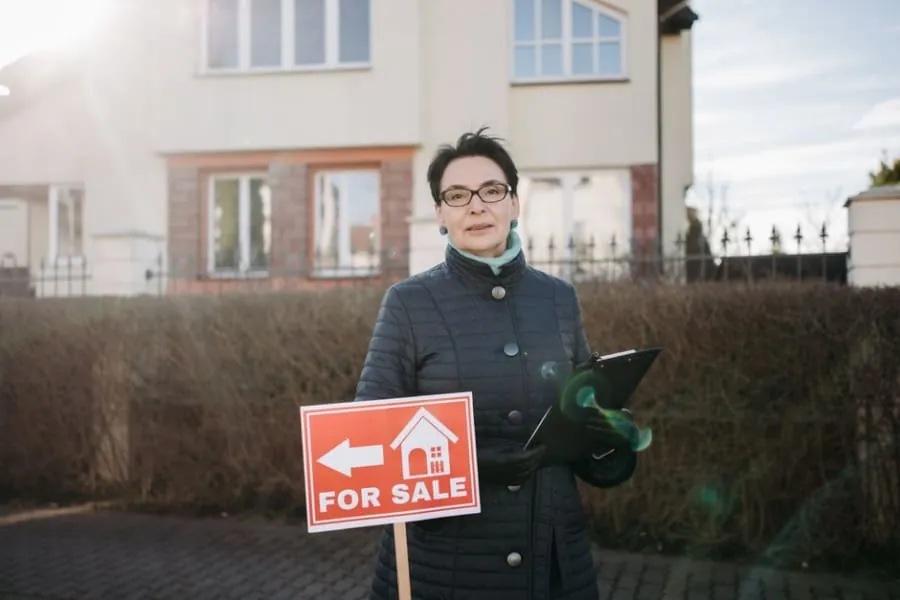A homeowner outside a house with a new driveway