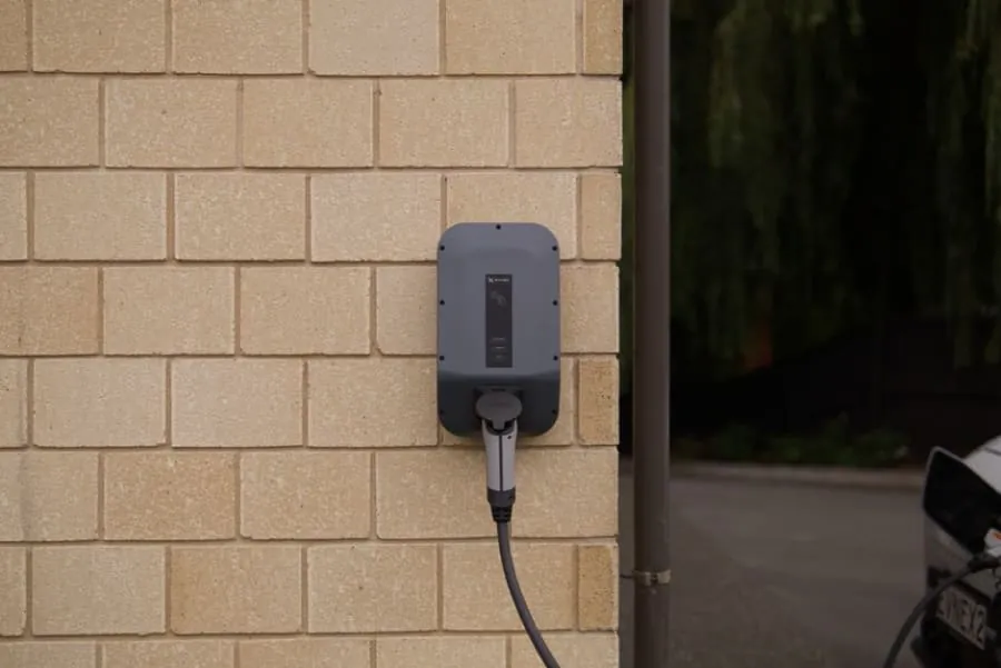 A home EV chargepoint mounted on a house wall