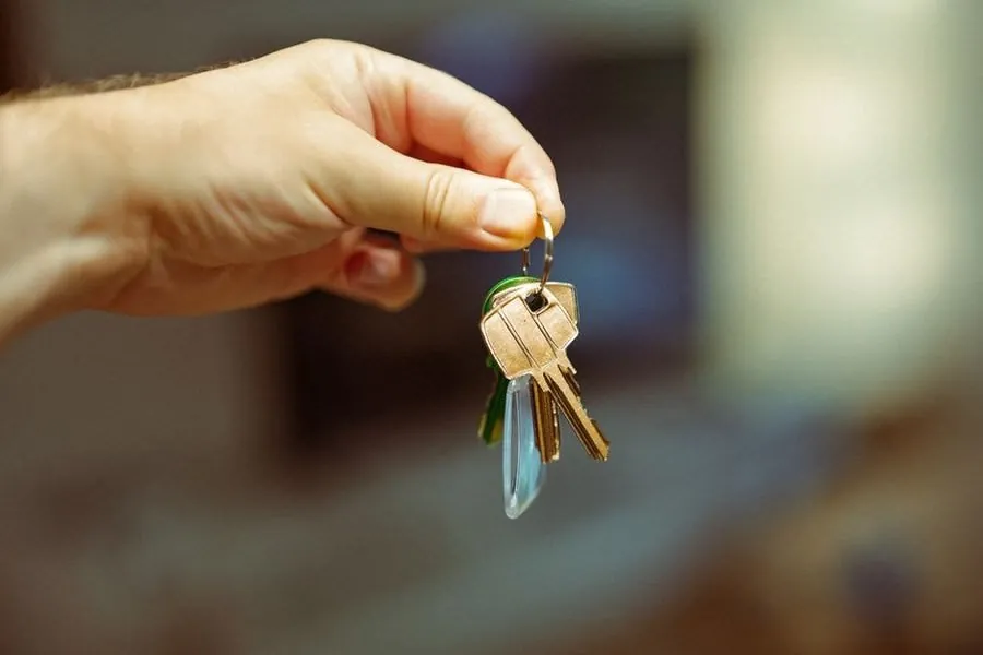 House keys changing hands, the moment a driveway guarantee should already be resolved