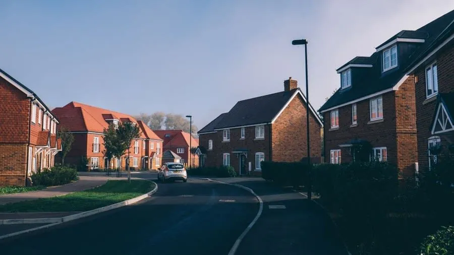 A street of red-brick houses with tidy frontages, the kerb appeal a Rochdale let property competes on