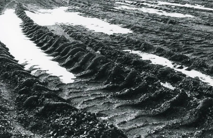 Water-filled tyre ruts in soft ground, the state many Rochdale rental frontages reach after a wet winter