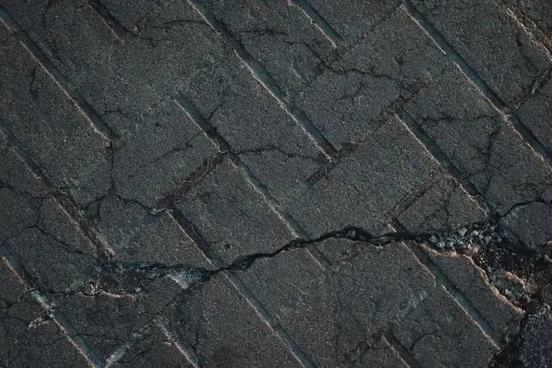 Cracked and broken old driveway surface awaiting replacement