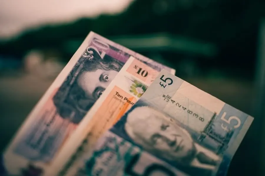 A handful of British banknotes representing payment for a resin driveway