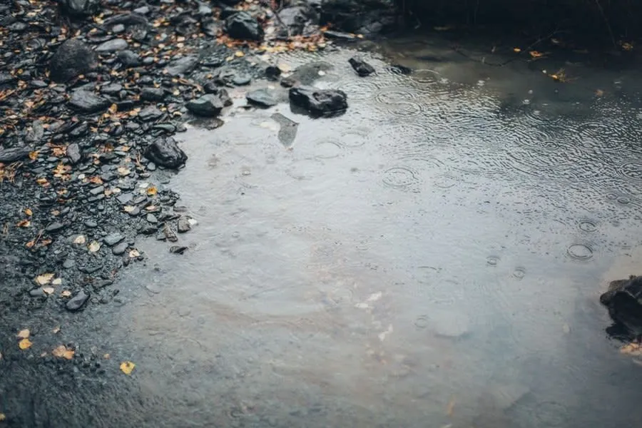 Rainwater draining through loose stone into the ground below