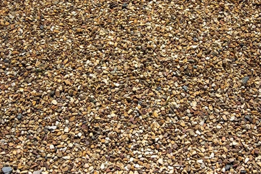 Golden aggregate stone of the kind ordered in advance for a resin bound driveway