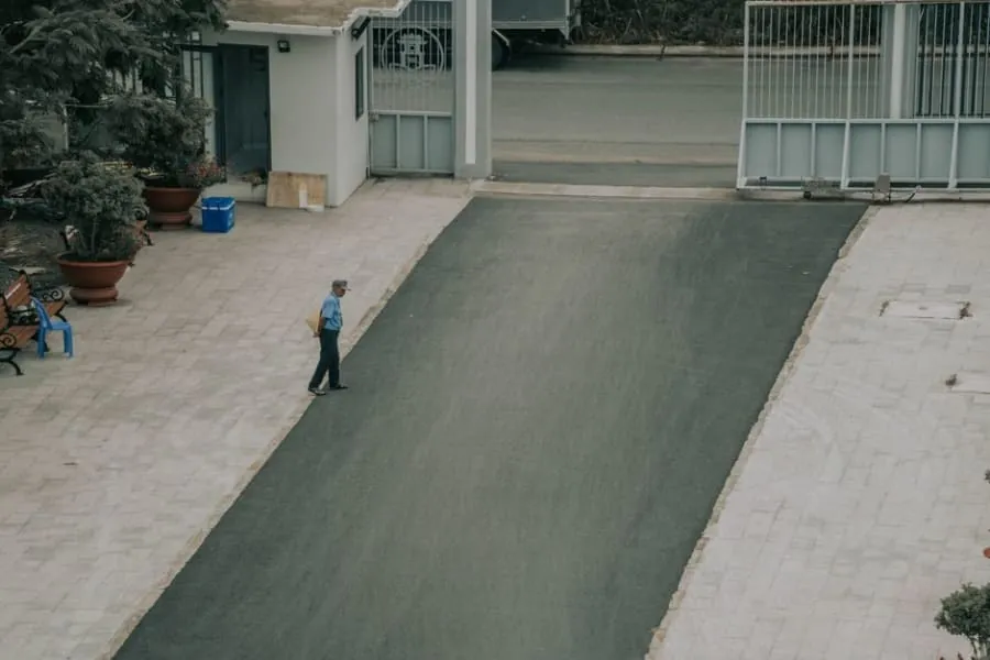 A contractor laying a new resin driveway surface