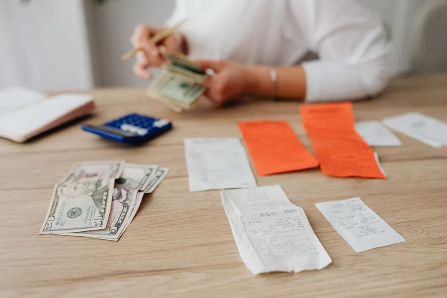Working out the cost of a resin driveway with a calculator and paperwork