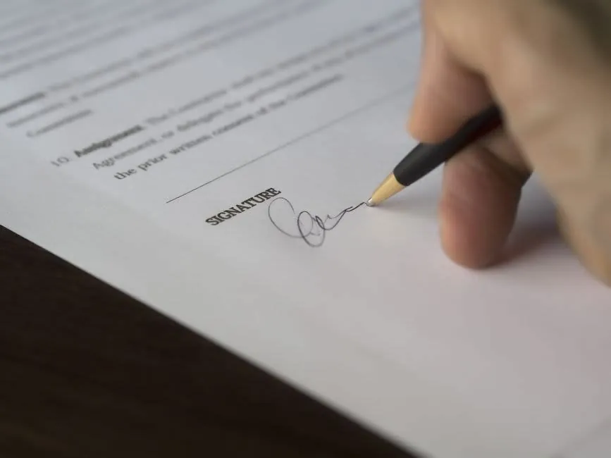 A homeowner signing a written driveway contract before paying a deposit