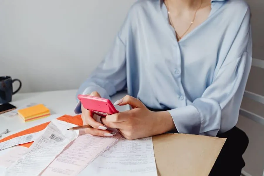 Household bills and a calculator laid out on a table