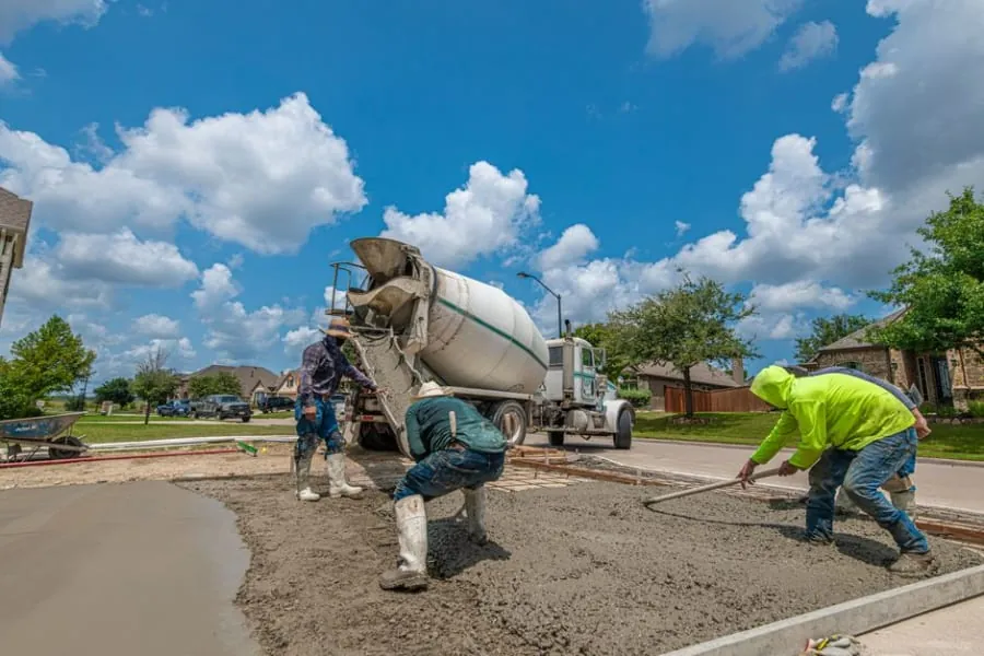 A driveway installer preparing a resin bound surface