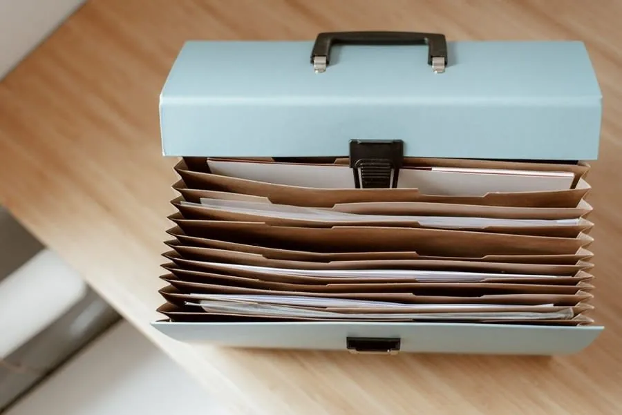 A folder of quotes, receipts and guarantee documents kept from a driveway project