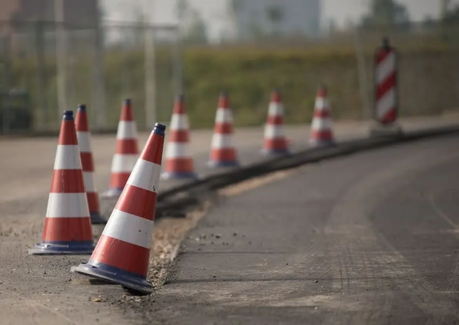 Traffic cones and barriers set out around utility works in a street