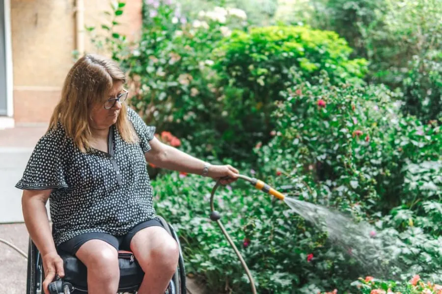 A wheelchair user outside a home