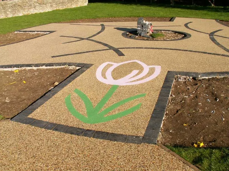 Flower shape in a resin surface for a children's playing area.