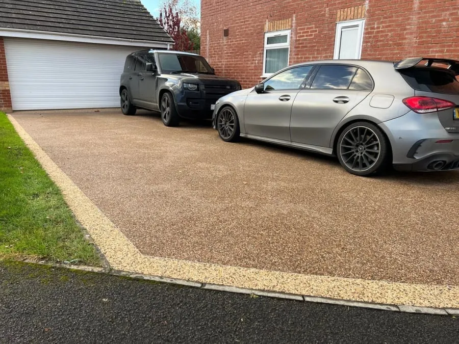 Two-tone resin driveway with yellow and gold.