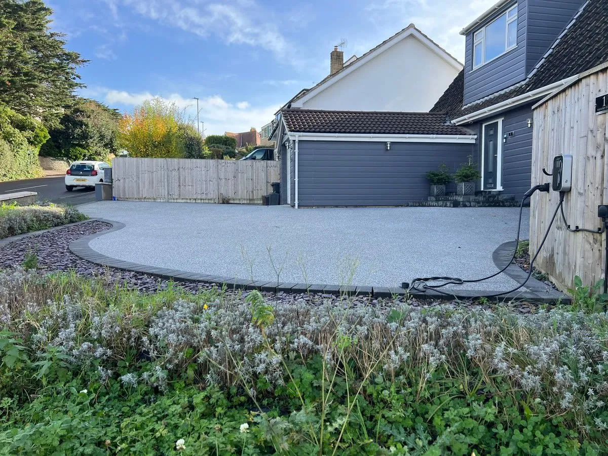 A grey resin bound driveway in Rochdale with an open, unsealed stone texture
