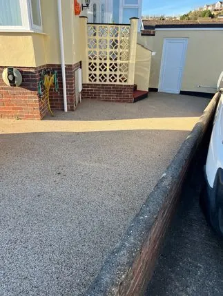 A resin bound patio compared with Indian sandstone paving in Rochdale