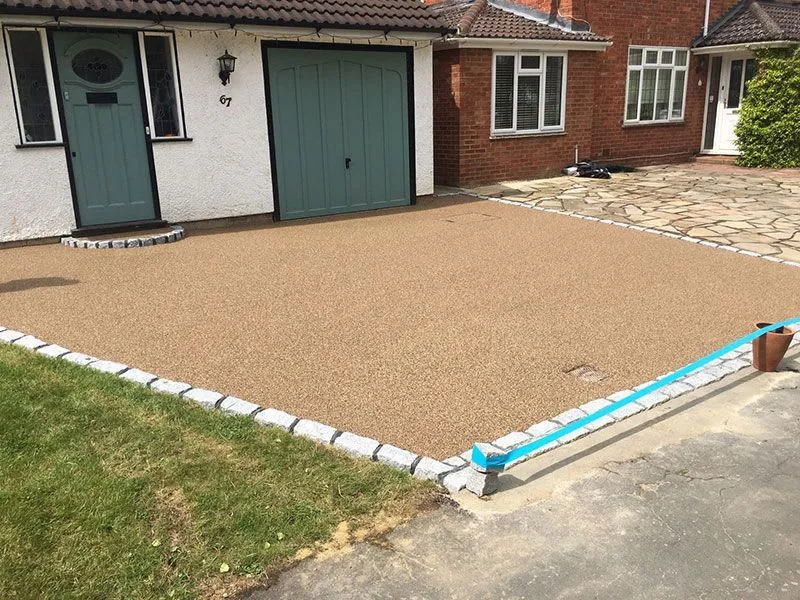A resin driveway with an electric gate.