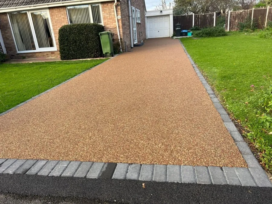A block paving driveway with gravel and bricks leading to a house in Rochdale.