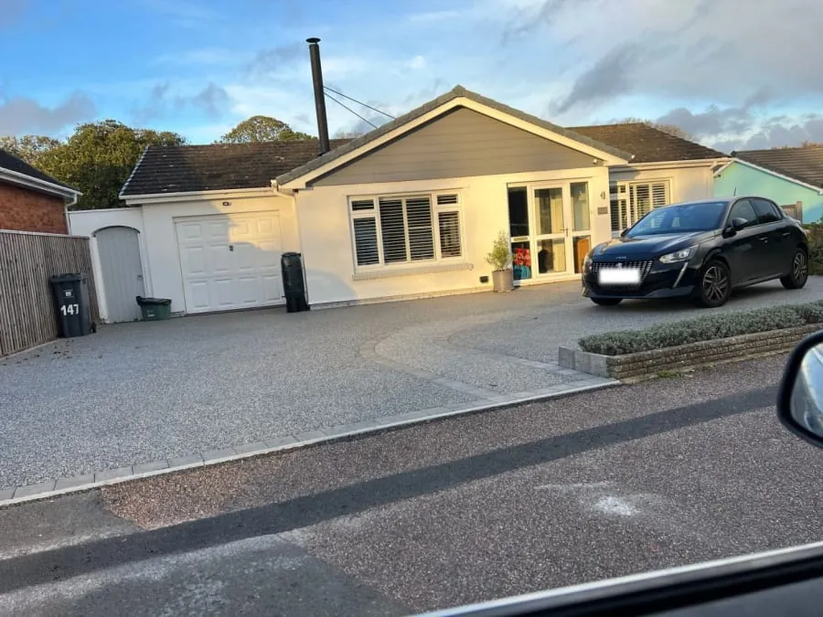 Resin driveway installation with a block paving and resin pathway leading to the house.